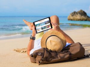 Blogging travel blog beach man reading ipad