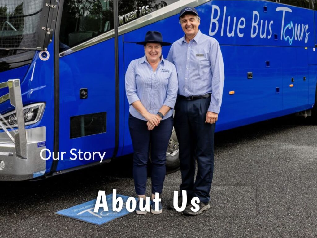 Blue Bus Tours owners Sandra and Geoff stand proudly in front of their big blue coach for their about us page