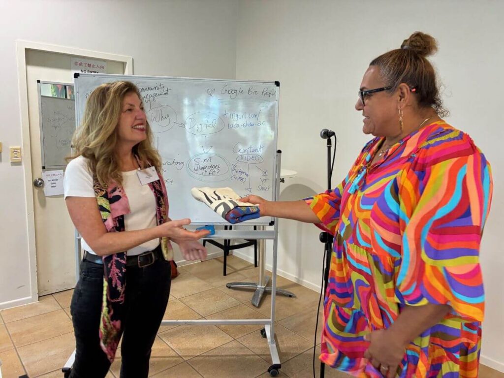 Liz accepts a gift from Daphne de Jersey at the Elevate 2025 Indigenous Artworker Program brought to you by the Indigenous Art Centre Alliance.