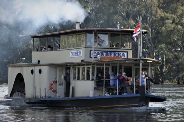 Paddlewheel steamboat named Canberra on the Murray River with tourists aboard.