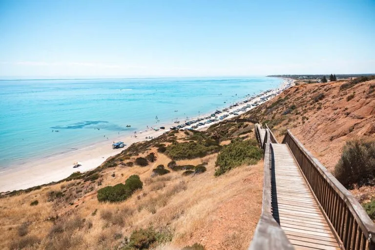 Wooden boardwalk descends steep sandy cliff to Sellicks Beach, South Australia.