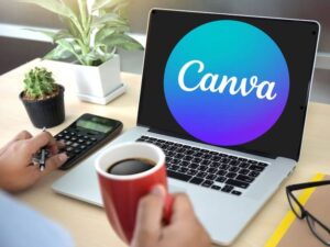 Laptop displaying Canva logo with calculator, coffee cup and potted plants on desk.
