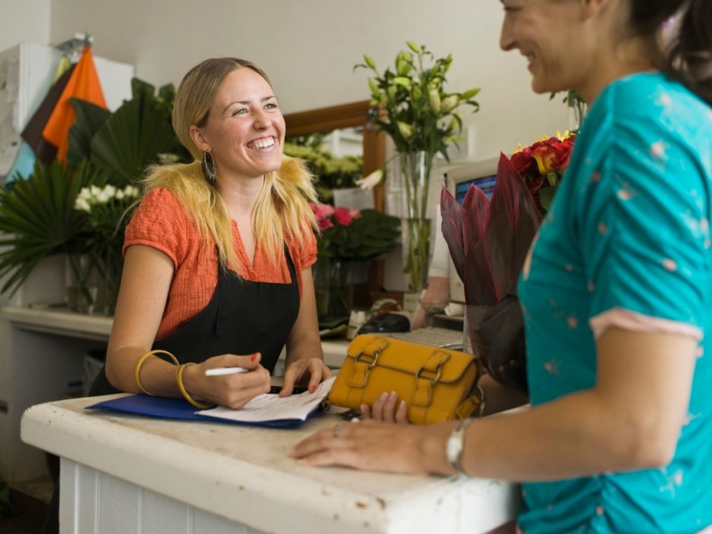 Visitor to retail outlet intereacting with shop manager