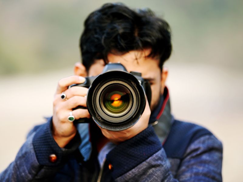 develop a content bank - photo of a man with a SLR camera taking a photo